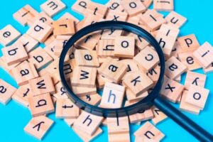 Scrabble tiles with magnifying glass